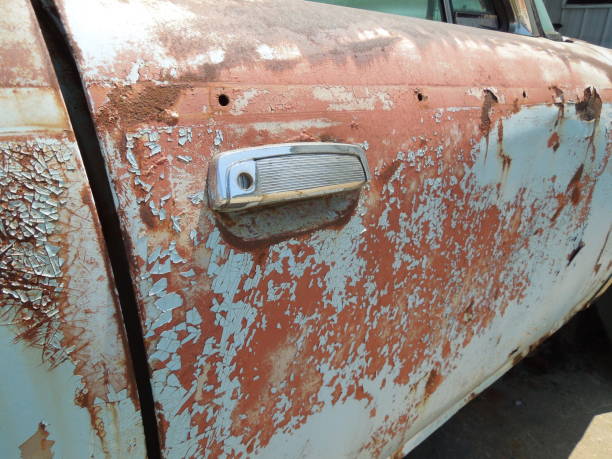 istock Weathered and peeling old car door 1166906906