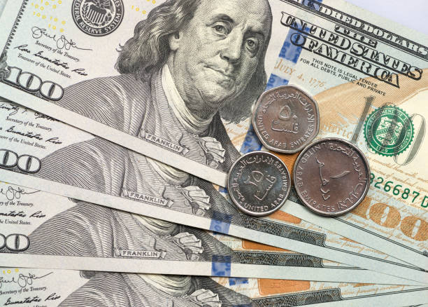 istock UAE Dirham coin on top of dollar bills 1166910008