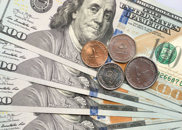 istock UAE Dirham coin on top of dollar bills 1166911951
