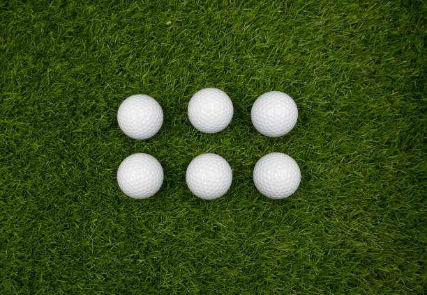 istock Six golf balls are on green grass 1166928785