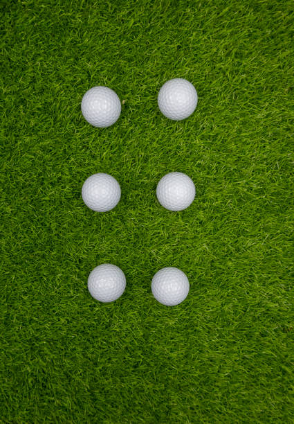istock Six golf balls are on green grass 1166928789