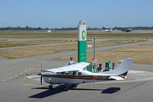 Christchurch, New Zealand, December 12, 2014: The unidentified pilot of a light plane refuels his plane at Christchurch International Airport on December 12, 2014