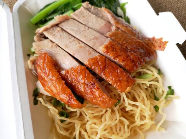 istock noodle with roasted duck on takeaway paper food box 1166933551