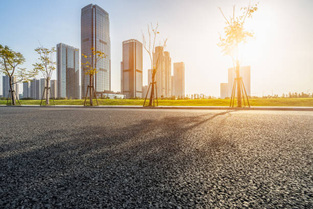 istock empty urban road and modern buildings at a sunny day, china 1166936487