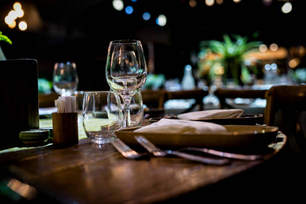 istock Luxury table settings for fine dining with and glassware, beautiful blurred  background. For events, weddings.  Preparation for holiday  Christmas and Hanukkah dinner night. props for weddings, birthdays, and celebrations. 1166939434