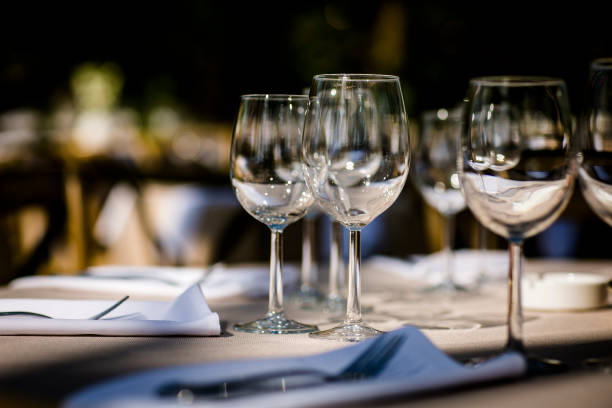 istock Luxury table settings for fine dining with and glassware, beautiful blurred  background. For events, weddings.  Preparation for holiday  Christmas and Hanukkah dinner night. props for weddings, birthdays, and celebrations. 1166939550