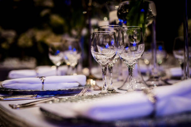 istock Luxury table settings for fine dining with and glassware, beautiful blurred  background. For events, weddings.  Preparation for holiday  Christmas and Hanukkah dinner night. props for weddings, birthdays, and celebrations. 1166939575