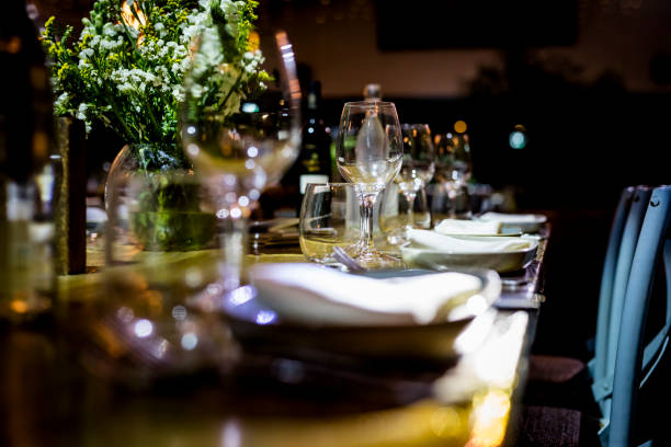 istock Luxury table settings for fine dining with and glassware, beautiful blurred  background. For events, weddings.  Preparation for holiday  Christmas and Hanukkah dinner night. props for weddings, birthdays, and celebrations. 1166939651