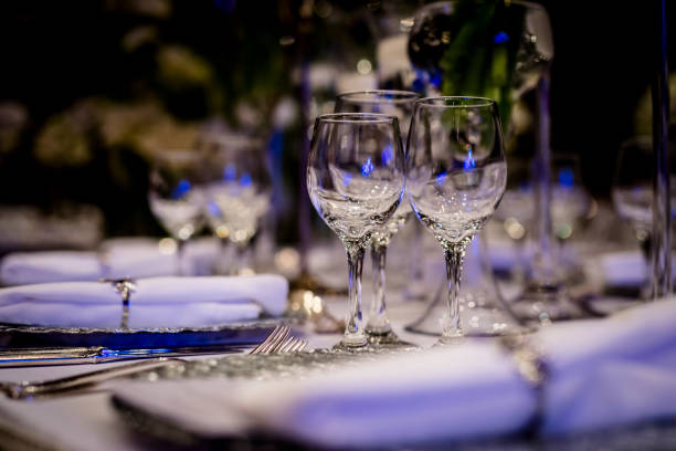 istock Luxury table settings for fine dining with and glassware, beautiful blurred  background. For events, weddings.  Preparation for holiday  Christmas and Hanukkah dinner night. props for weddings, birthdays, and celebrations. 1166940254