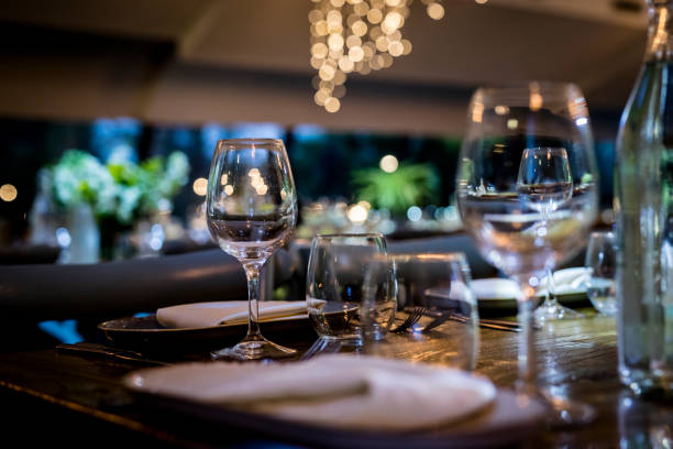 istock Luxury table settings for fine dining with and glassware, beautiful blurred  background. For events, weddings.  Preparation for holiday  Christmas and Hanukkah dinner night. props for weddings, birthdays, and celebrations. 1166940391