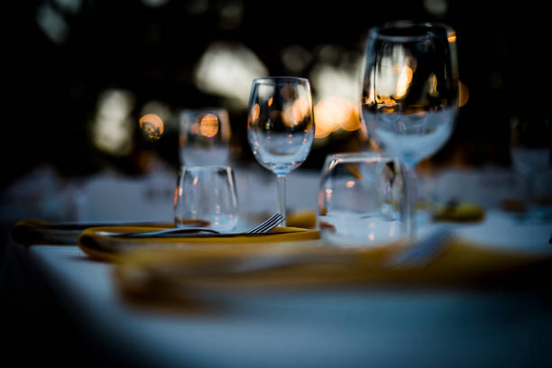 istock Luxury table settings for fine dining with and glassware, beautiful blurred  background. For events, weddings.  Preparation for holiday  Christmas and Hanukkah dinner night. props for weddings, birthdays, and celebrations. 1166940421