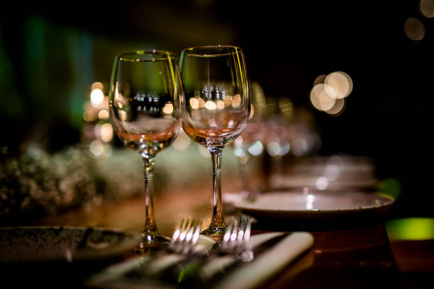 istock Luxury table settings for fine dining with and glassware, beautiful blurred  background. For events, weddings.  Preparation for holiday  Christmas and Hanukkah dinner night. props for weddings, birthdays, and celebrations. 1166940507