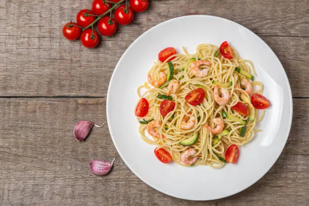 Pasta with shrimp, tomatoes and zucchini. Dietary food.