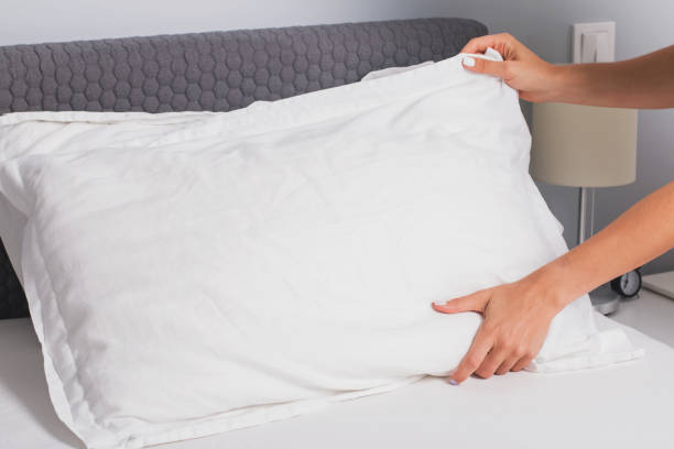 istock Woman's hands close-up making the bed. 1166940591