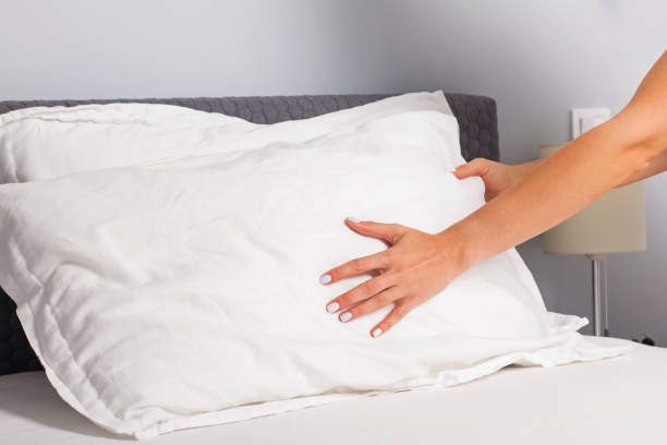 istock Woman's hands close-up making the bed. 1166940594