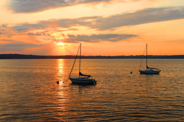 istock Yachts drifting on the lake during beautiful summer sunset. 1166940614