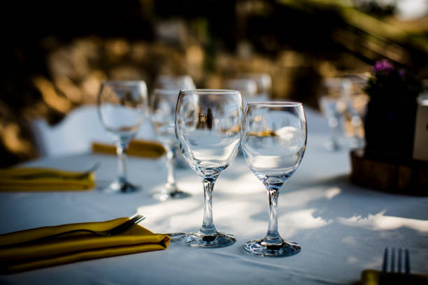 istock Luxury table settings for fine dining with and glassware, beautiful blurred  background. For events, weddings.  Preparation for holiday  Christmas and Hanukkah dinner night. props for weddings, birthdays, and celebrations. 1166940868