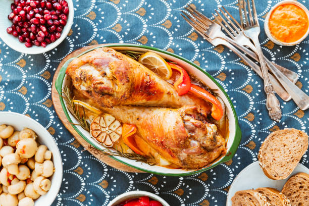 istock Festive dish for Thanksgiving, roasted turkey legs with vegetables on a table with snacks. Top view, flat lay. 1166940903
