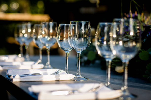 istock Luxury table settings for fine dining with and glassware, beautiful blurred  background. For events, weddings.  Preparation for holiday  Christmas and Hanukkah dinner night. props for weddings, birthdays, and celebrations. 1166940904