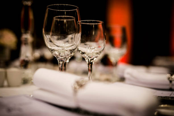 istock Luxury table settings for fine dining with and glassware, beautiful blurred  background. For events, weddings.  Preparation for holiday  Christmas and Hanukkah dinner night. props for weddings, birthdays, and celebrations. 1166940906