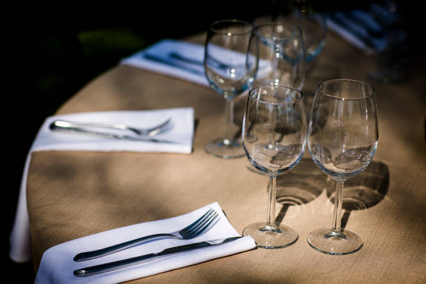 istock Luxury table settings for fine dining with and glassware, beautiful blurred  background. For events, weddings.  Preparation for holiday  Christmas and Hanukkah dinner night. props for weddings, birthdays, and celebrations. 1166940996