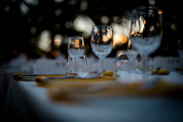 istock Luxury table settings for fine dining with and glassware, beautiful blurred  background. For events, weddings.  Preparation for holiday  Christmas and Hanukkah dinner night. props for weddings, birthdays, and celebrations. 1166941616