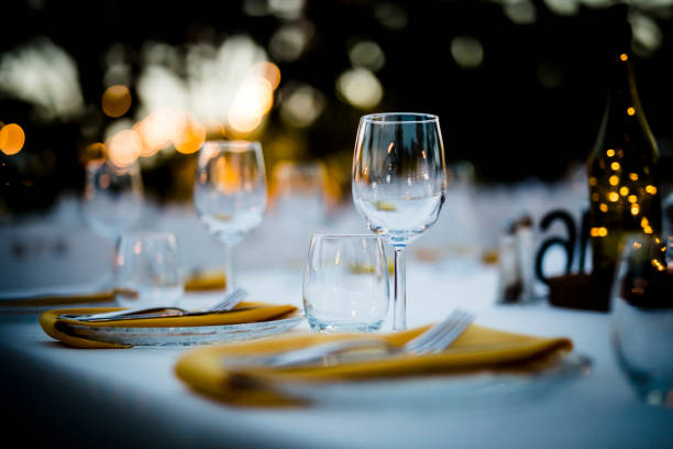 istock Luxury table settings for fine dining with and glassware, beautiful blurred  background. For events, weddings.  Preparation for holiday  Christmas and Hanukkah dinner night. props for weddings, birthdays, and celebrations. 1166941634