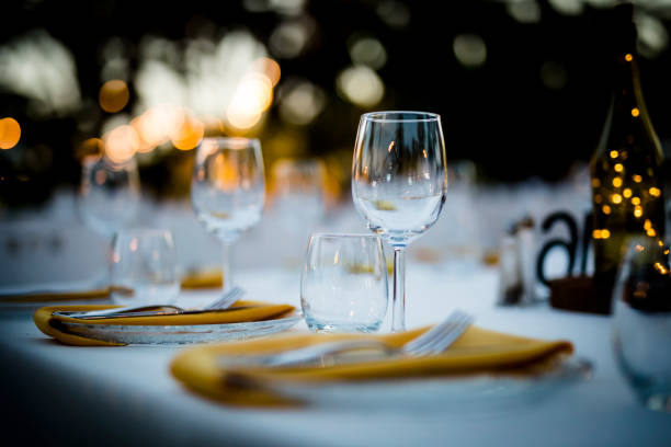 istock Luxury table settings for fine dining with and glassware, beautiful blurred  background. For events, weddings.  Preparation for holiday  Christmas and Hanukkah dinner night. props for weddings, birthdays, and celebrations. 1166941705