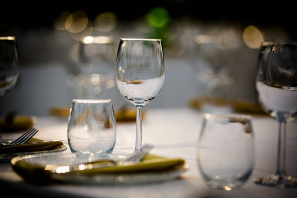 istock Luxury table settings for fine dining with and glassware, beautiful blurred  background. For events, weddings.  Preparation for holiday  Christmas and Hanukkah dinner night. props for weddings, birthdays, and celebrations. 1166941780
