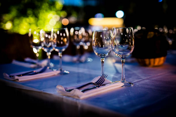 istock Luxury table settings for fine dining with and glassware, beautiful blurred  background. For events, weddings.  Preparation for holiday  Christmas and Hanukkah dinner night. props for weddings, birthdays, and celebrations. 1166941797