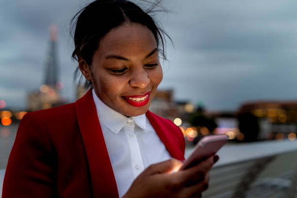 istock Businesswoman reading message on mobile phone 1166944190