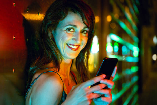 istock Pretty woman using smart phone at the street 1166944215