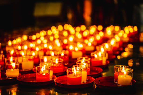 istock Lit Prayer Candles Close Up in Black Background. Hope and Successful Concept. 1166945455