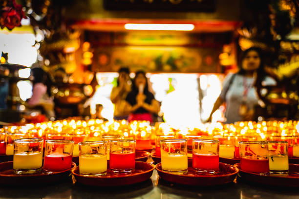 istock Lit Prayer Candles Close Up in Black Background. Hope and Successful Concept. 1166945459