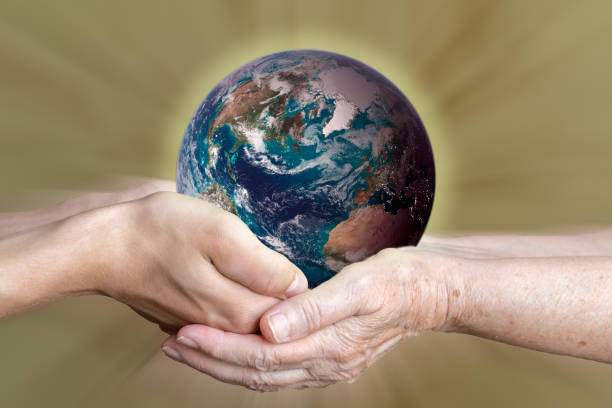 istock old and young person's hands holding planet earth, unity concept. elements of this images furnished by nasa 1166945476