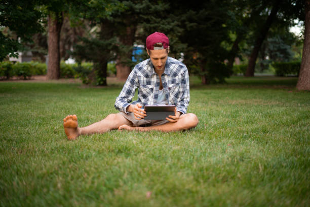 istock young male freelancer working on a tablet and typing the text 1166945567