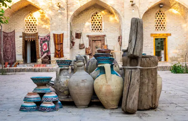 Large earthenware jugs in inner yard of old center of Bukhara, Uzbebkistan.