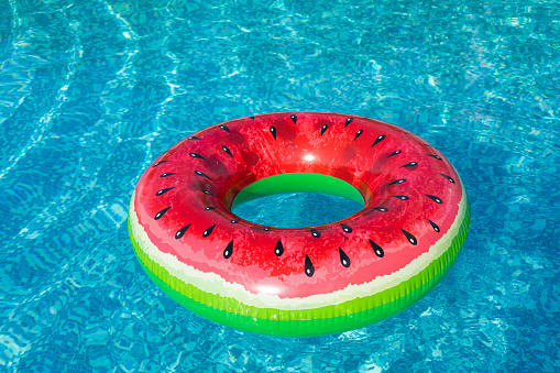 Close up picture of watermelon swimming ring floating in the pool