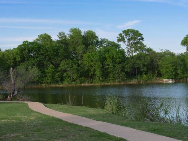istock Scenic refreshing view of a lake with a concrete walkway 1166955635