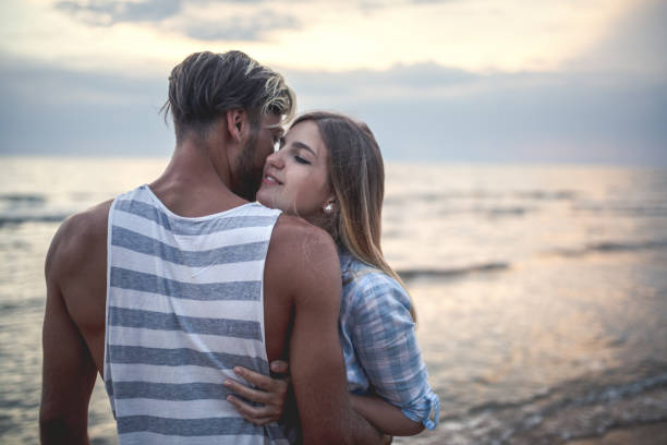 istock In love couple at the beach 1166960343