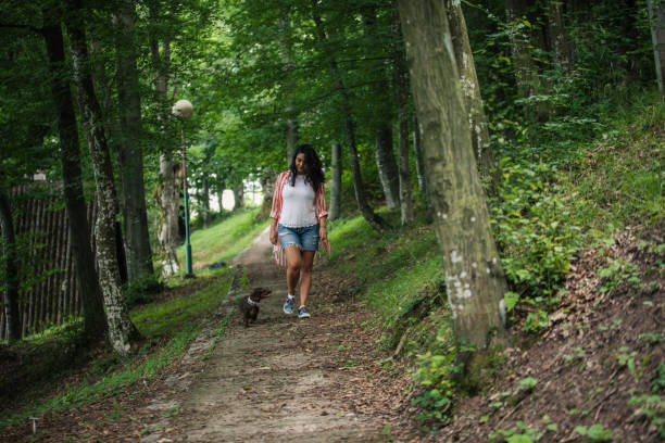 istock Woman and her pet taking a walk 1166961198