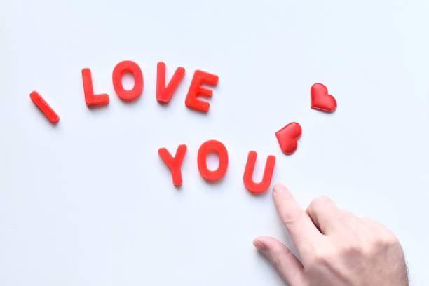 istock Close-Up Of Hand By Text And Heart Shape Over White Background 1166965703