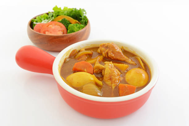 Delicious curry and salad isolated on white background