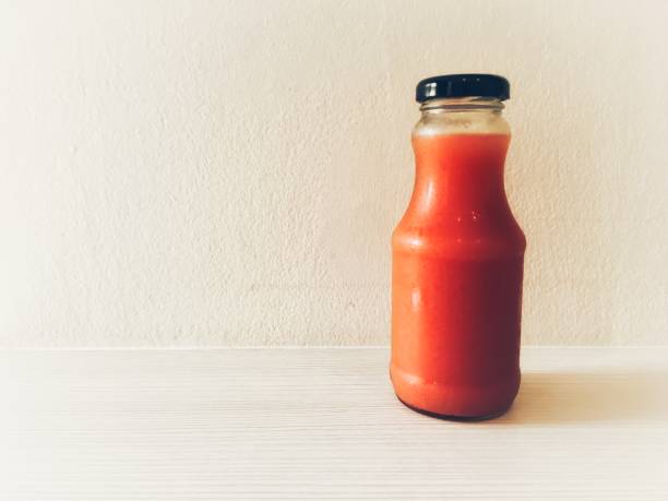 istock Fresh watermelon cold pressed juice in bottle on white wooden table background 1166970139