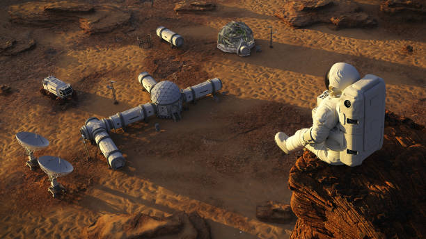 istock astronaut on planet Mars, sitting on a cliff above a research station  (3d space illustration) 1166971017