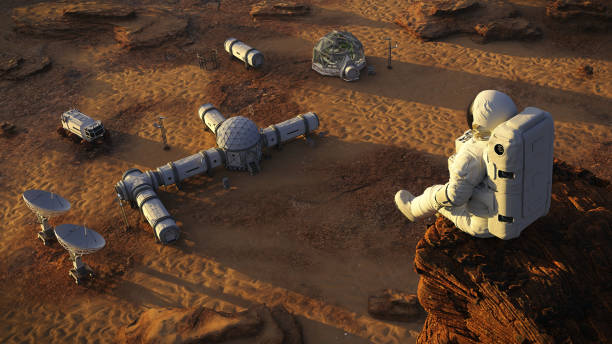 astronaut on planet Mars, sitting on a cliff above a research station  (3d space illustration) stock photo