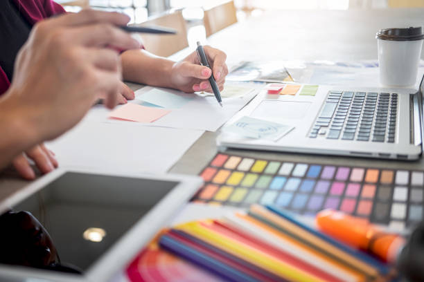istock Midsection Of Graphic Designers Working On Table 1166972533