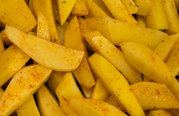 istock Fresh cut potatoes sliced  seasoned close-up 1166972730