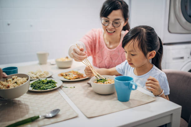 istock Mother and little daughter having lunch together 1166974530