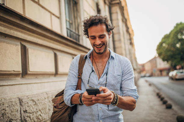 istock Handsome man using phone on the street 1166976351